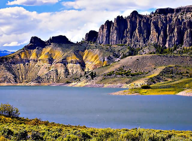 The winding fingers of Blue Mesa Reservior, near Gunnison, CO with fluffy clouds in the sky