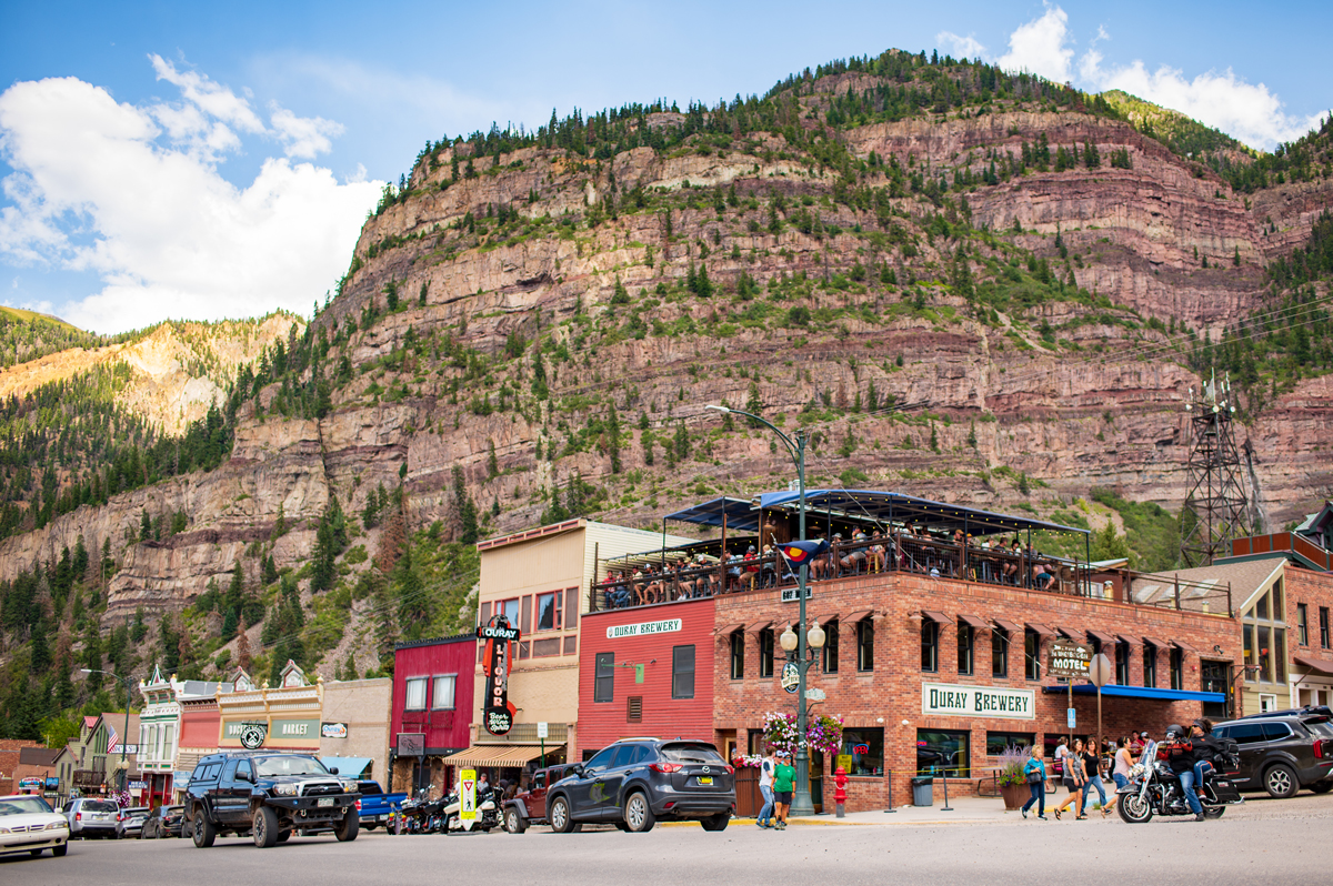 Historical Old-West buildings with canyon walls rising behind them in Ouray, Colorado