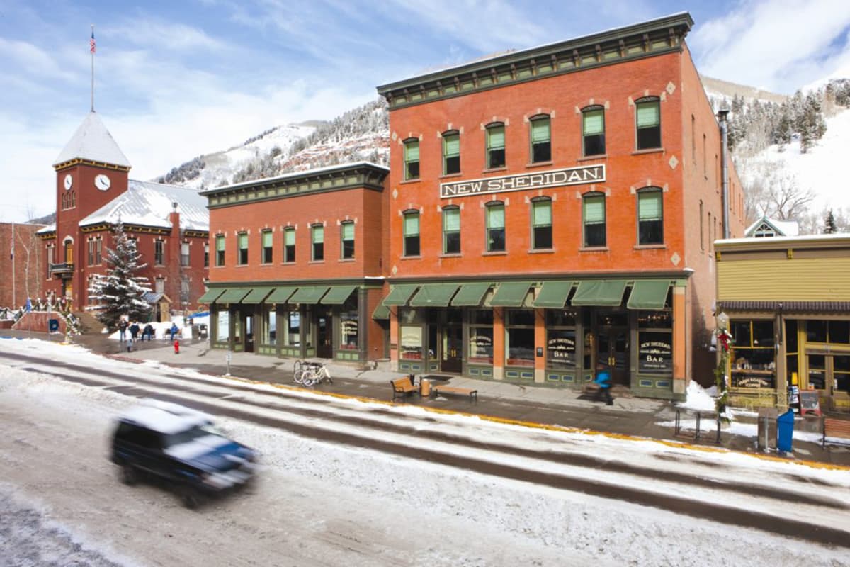 A light dusting of snow covers the city of Telluride and the red-brick New Sheridan hotel.
