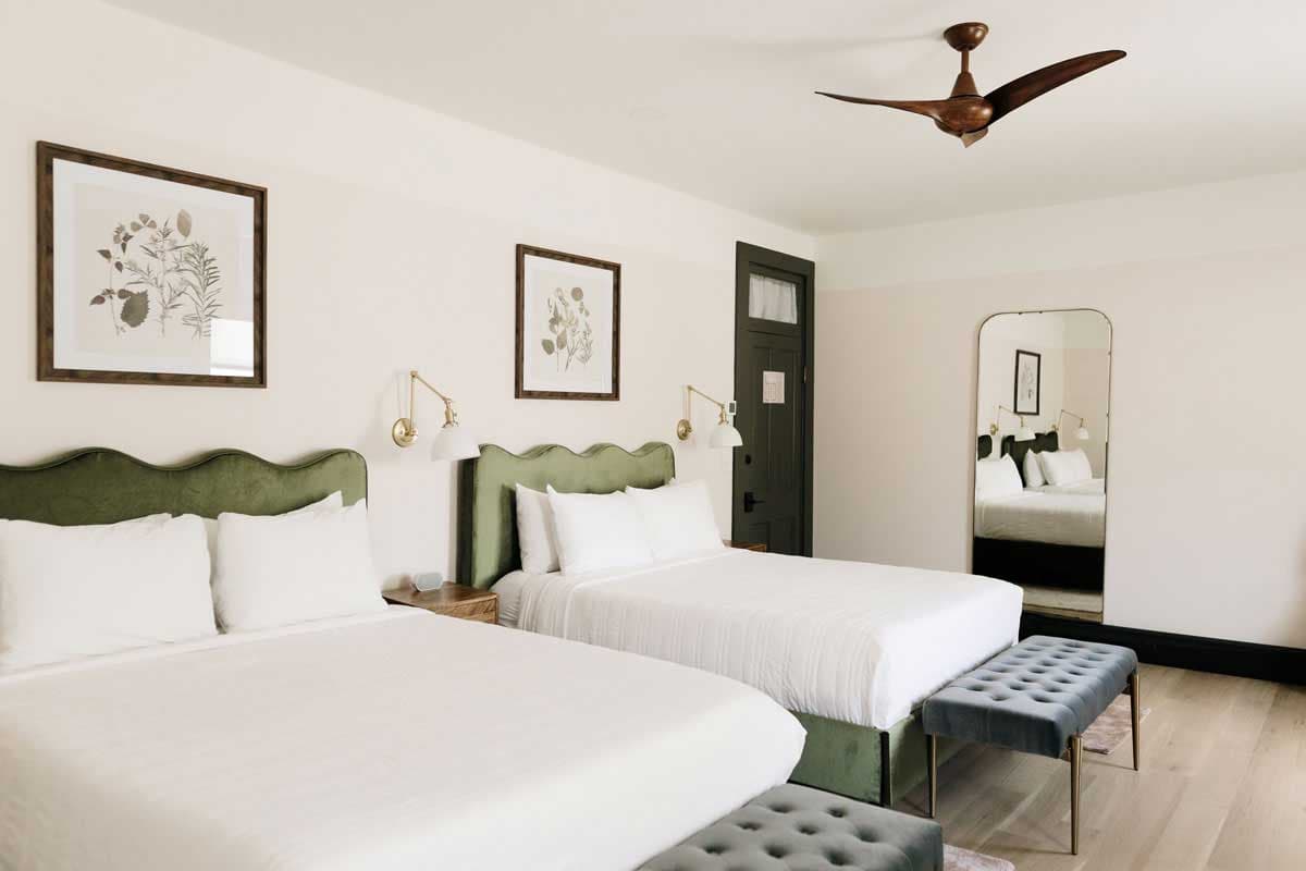 Double bed set up at The Rochester Hotel in Durango; clean lines, plush green bed stands and white walls