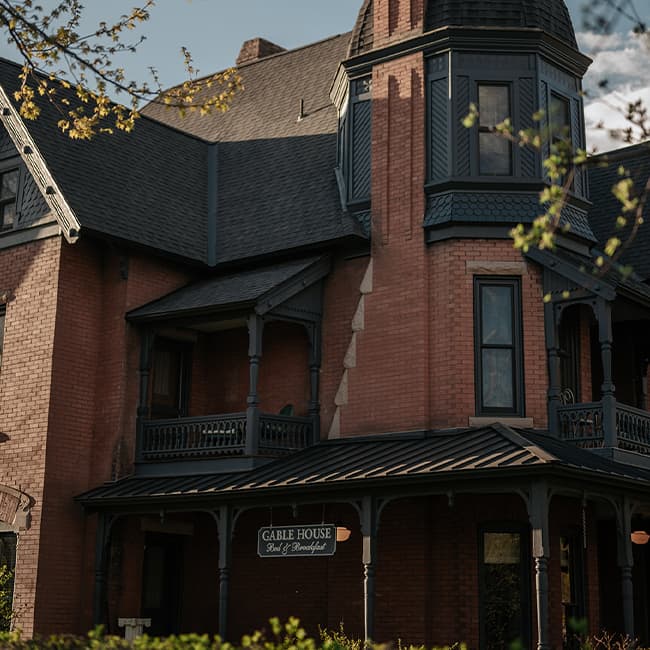 The Victorian-style, brick Gable House B&B stands in a verdant garden in Durango, Colorado.