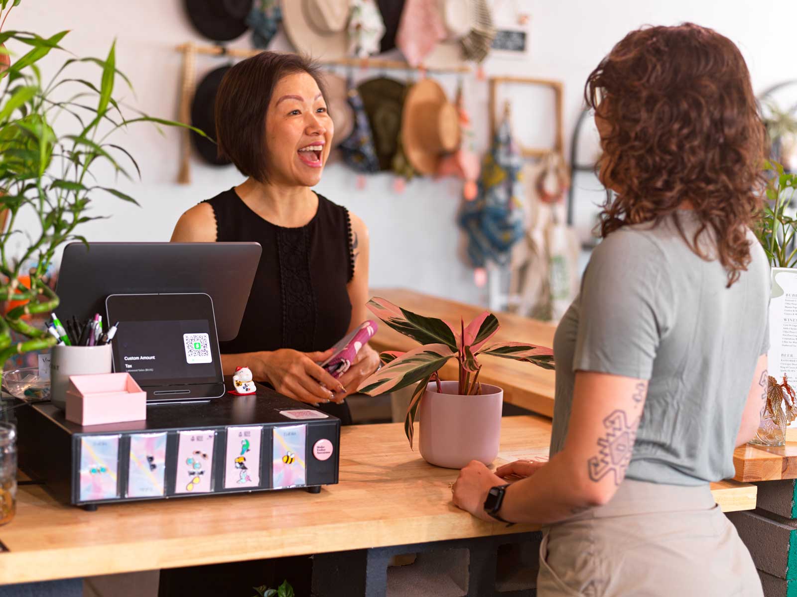 Two woman talk in a shop