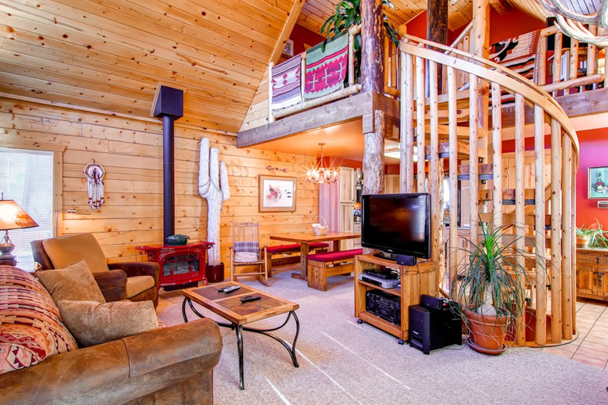 The interior of 597 Deerpath in Dillon, Colorado, is filled with bright wood elements, plush couches and a red gas stove for chilly nights.