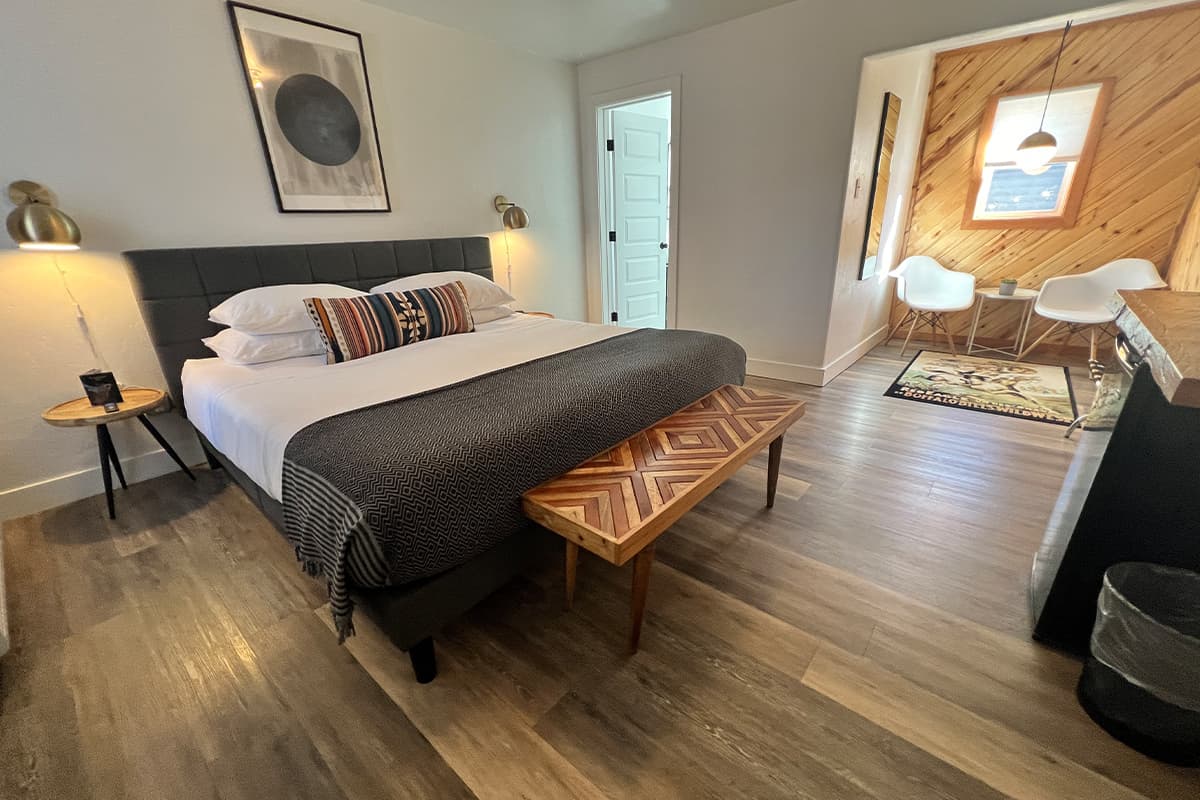 A guest room at Pagosa Springs' Nightingale Motel is filled with bright light and includes a buttery wood-paneled breakfast nook.