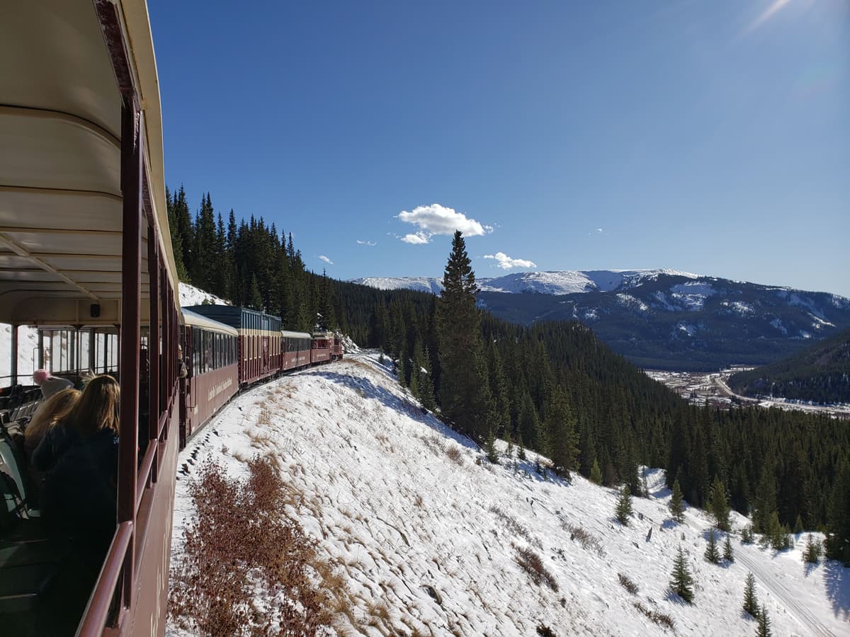 The Leadville Railroad Oktoberfest train ride winds through the mountains, which are just dusted with snow.