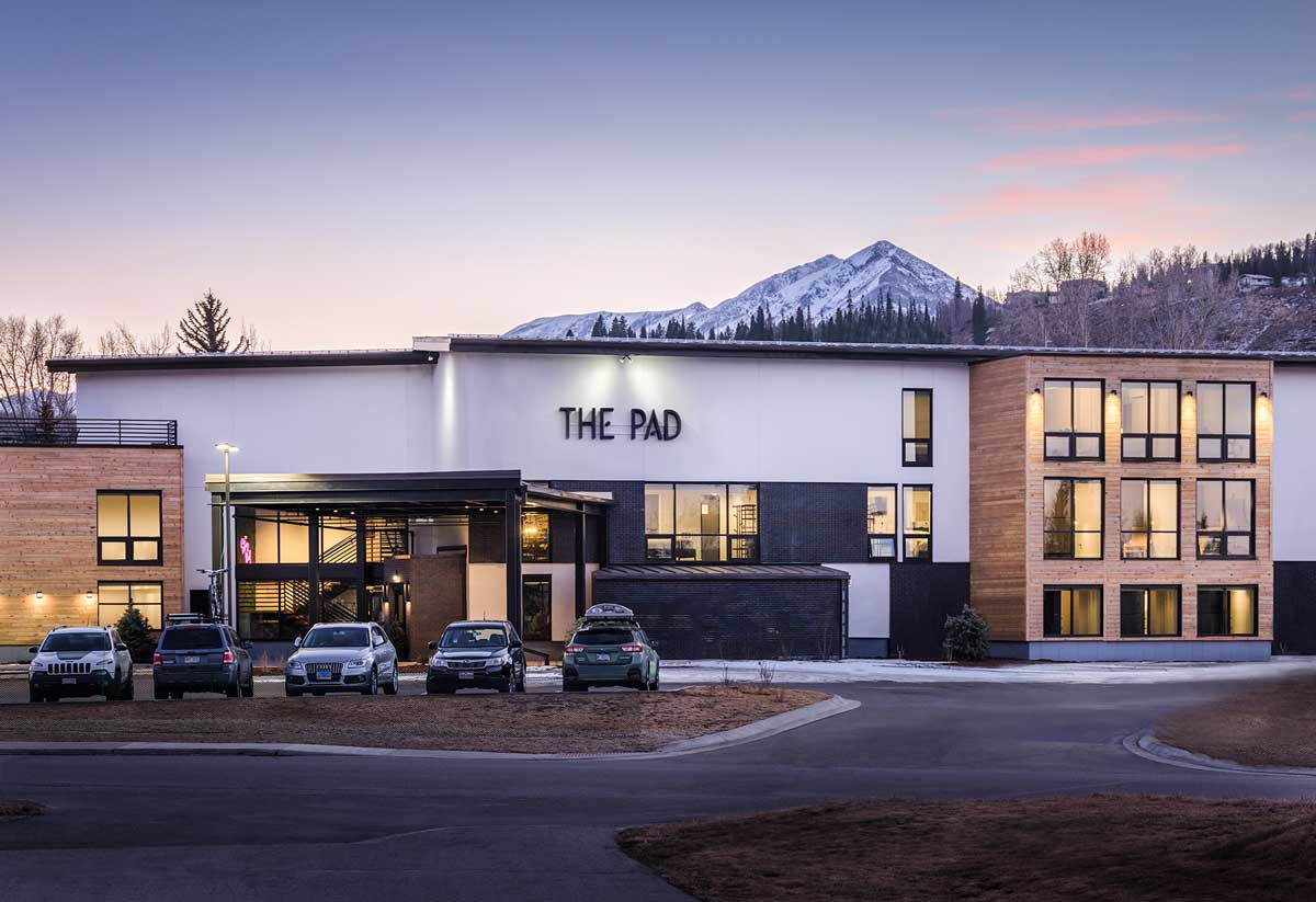 Front exterior of The Pad in Silverthorne showcases modern lines and snow-covered mountains in the background