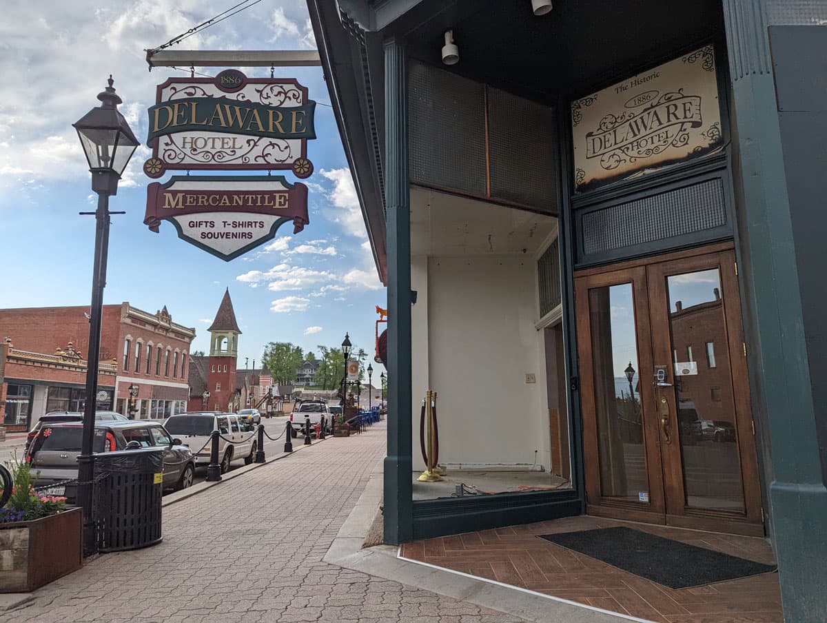 The entrance to the Delaware Hotel in Leadville with hanging sign to left