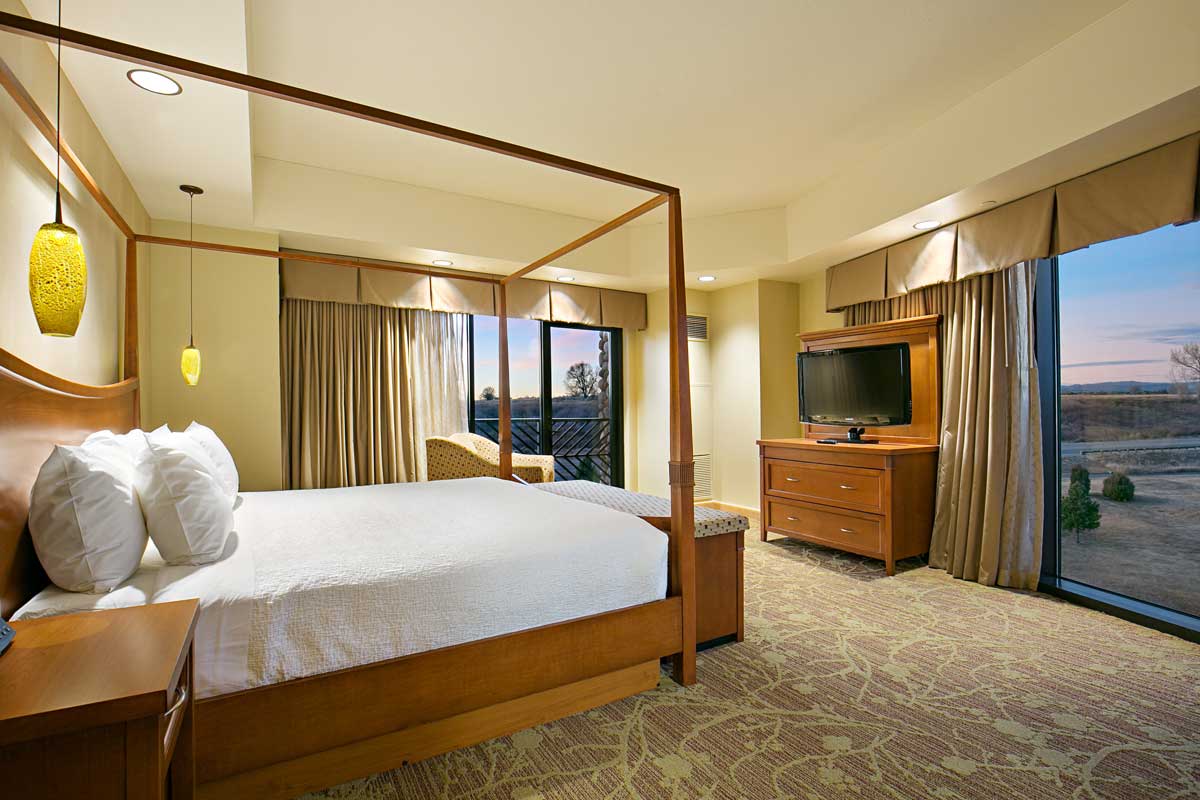 Sky Ute Casino Resort hotel room with a crisply made bed looking out through a floor-to-ceiling window