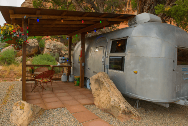 Canyon Hideout Bungalow Airstream seen next to a dark-wood pergola