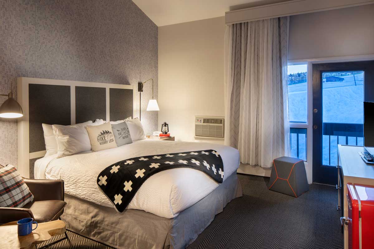 A guest room at the Gravity Haus Steamboat. The room features a king bed and a view of the slopes.