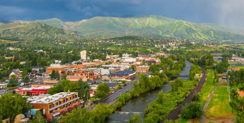 Aerial view of Steamboat Springs with lush mountains in the background.