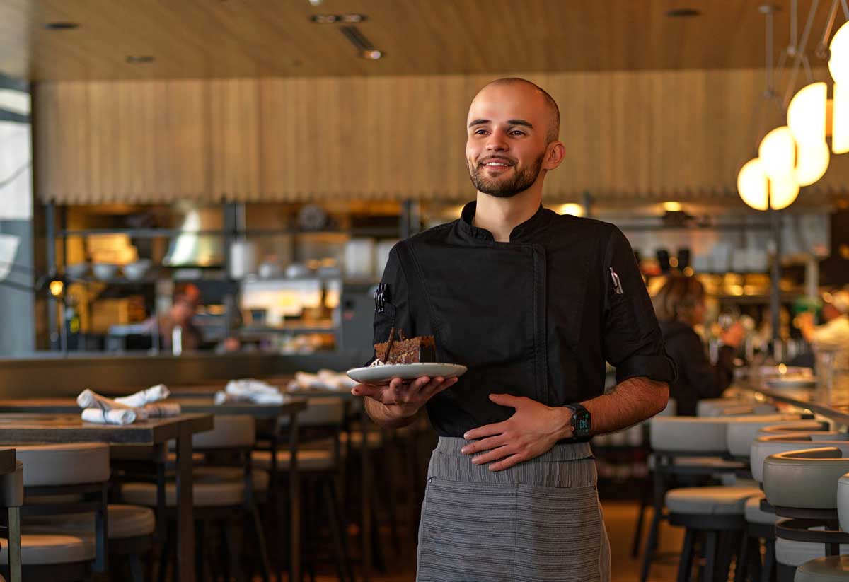 A waitor carries a plate of food