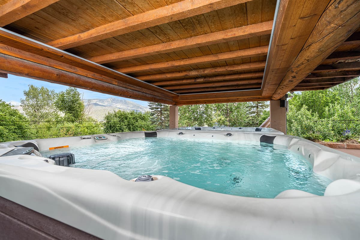 A large hot tub awaits guests with toasty waters and panoramic views at the Chipeta Lodge Resort +Spa in Ridgway, Colorado.