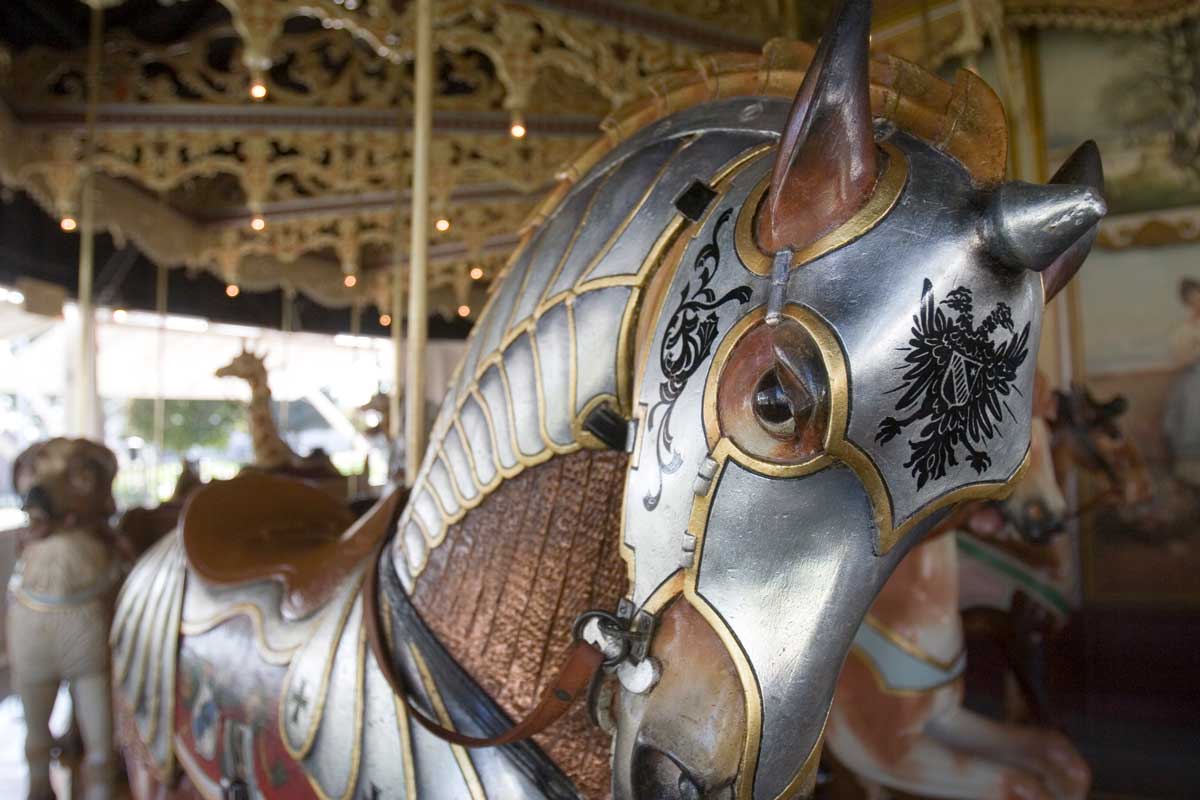 A close up of a detailed, painted silver carousel horse at the Kit Carson County Carousel in Burlington