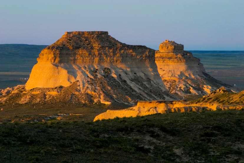 The Pawnee Buttes are tinged orange as the sun fades rise in Pawnee National Grassland near Fort Collins, Colorado.