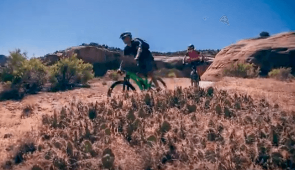Two people on a red-rock trail mountain bike 