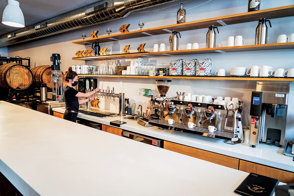 A barista makes a drink inside a coffee shop