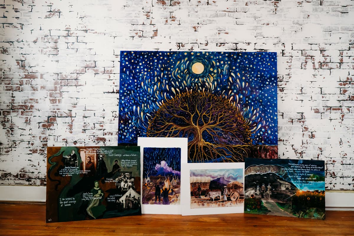 Life Chronicles' full collection of artworks stacked against a whitewashed brick wall