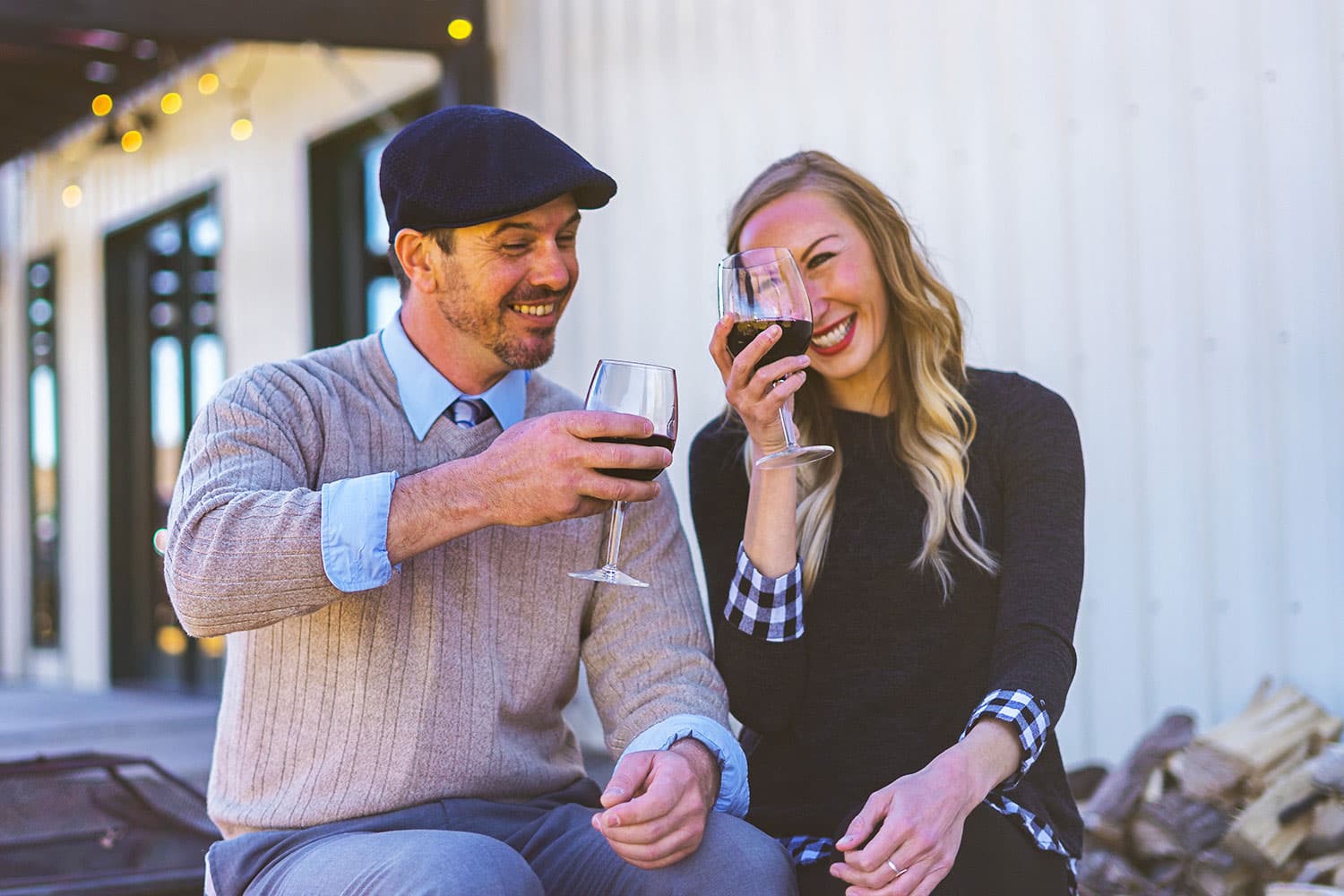 Two people raise their glasses of red wine at Palisade Restoration Vineyards