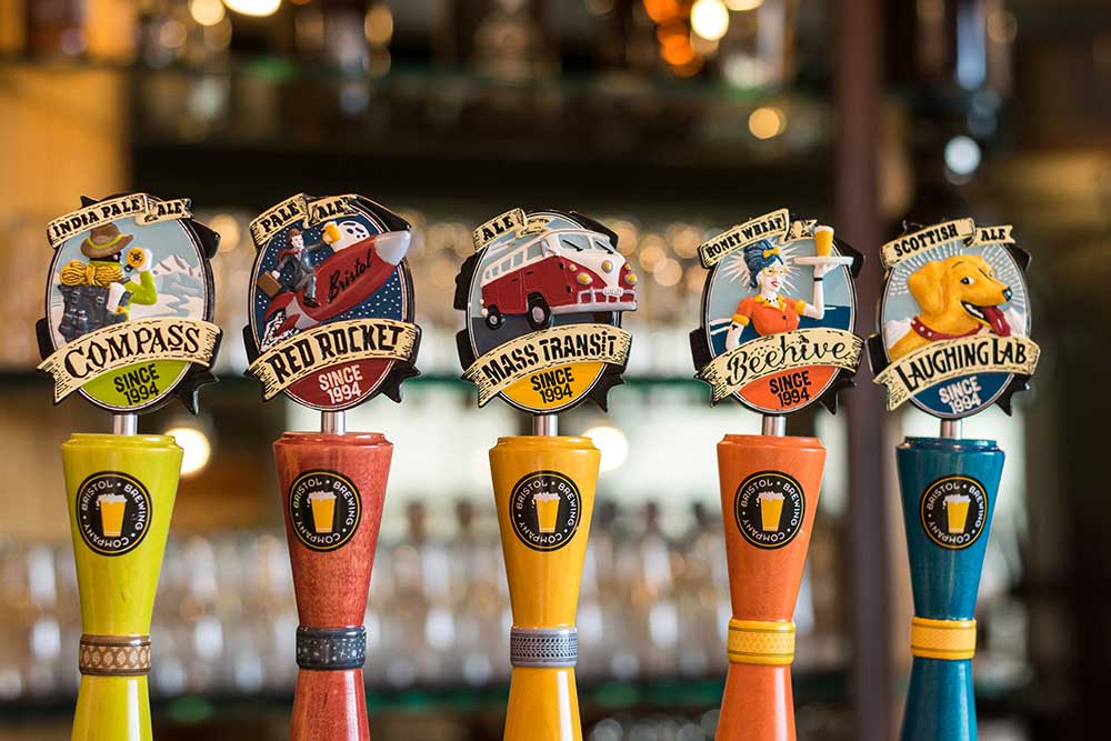 Five colorful beer tabs in yellow, orange, red and blue