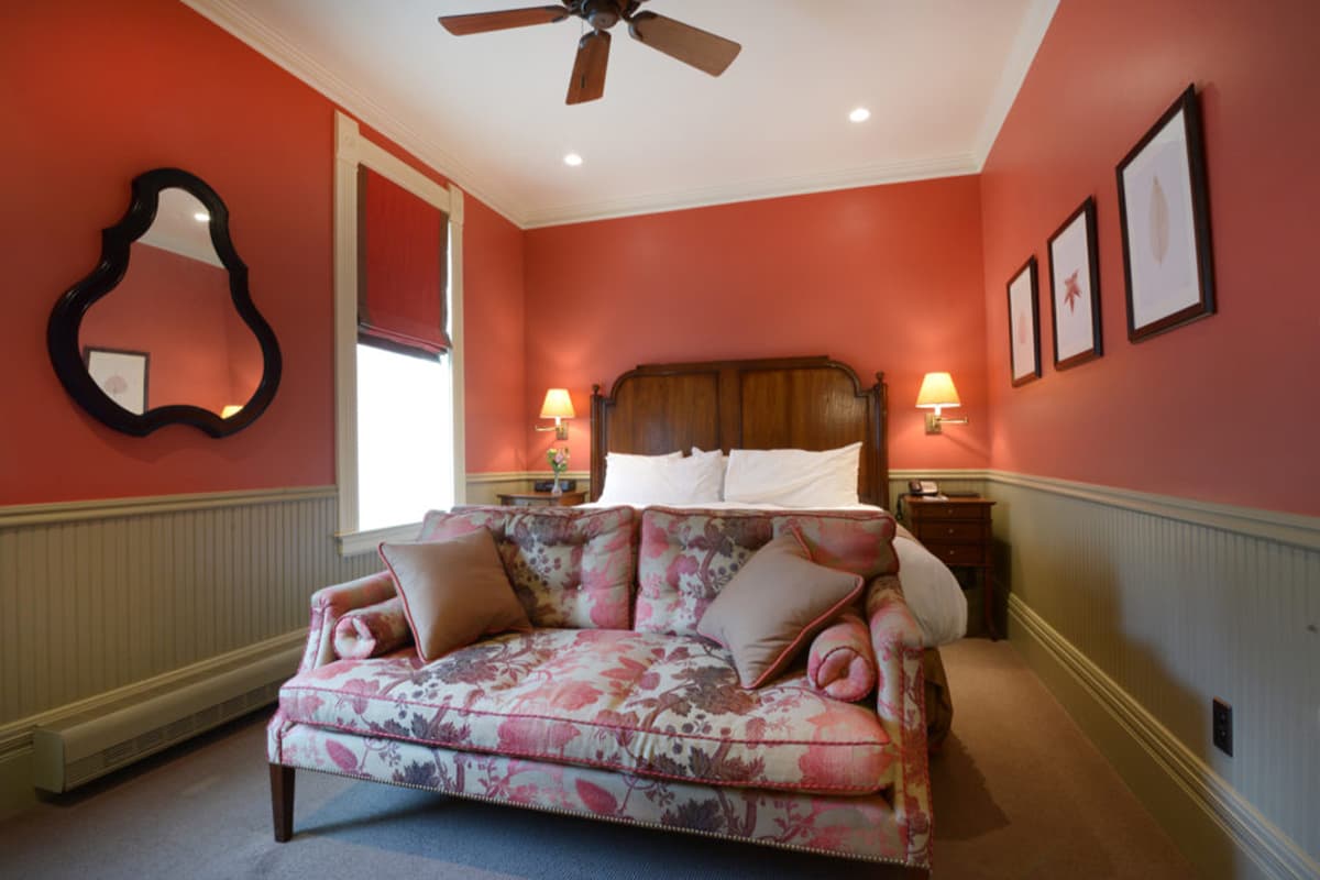 A cream- and salmon-colored guest room at the New Sheridan Hotel in Telluride, Colorado, awaits guests.