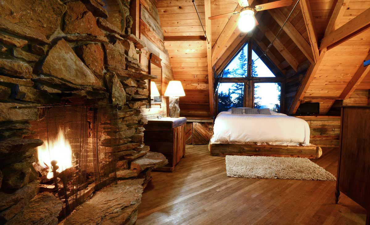 A master bedroom at The Observatory at Alta Lakes with a wood-burning fireplace