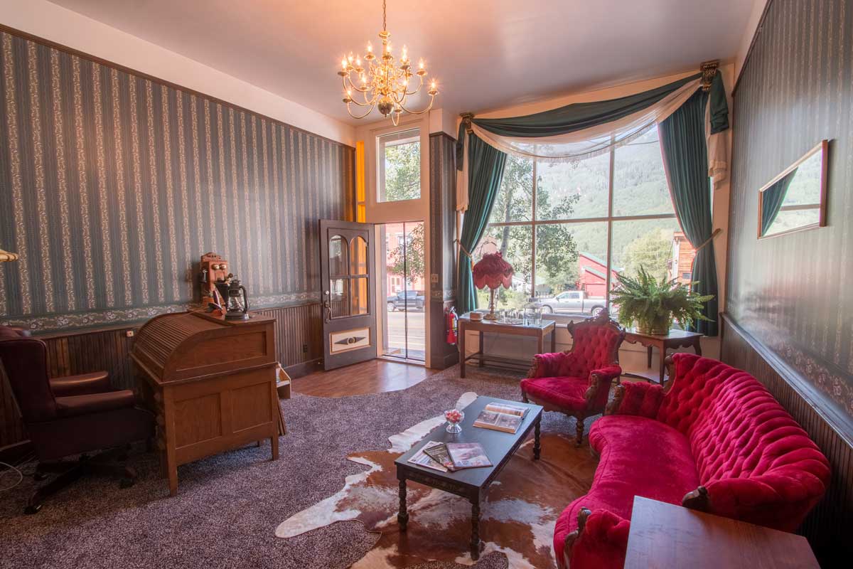Rico Mine Shaft Inn's reception area is decorated with period Victorian furniture, wallpaper and even a chandelier.