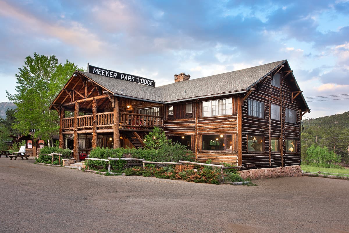 Near Allenspark, Colorado, the log-cabin buildings of Meeker Park Lodge welcome guests with stunning views of the surrounding peaks and forest.