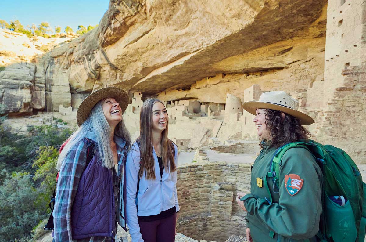 A mother and daughter listen to a park ranger at Mesa Verde National Park