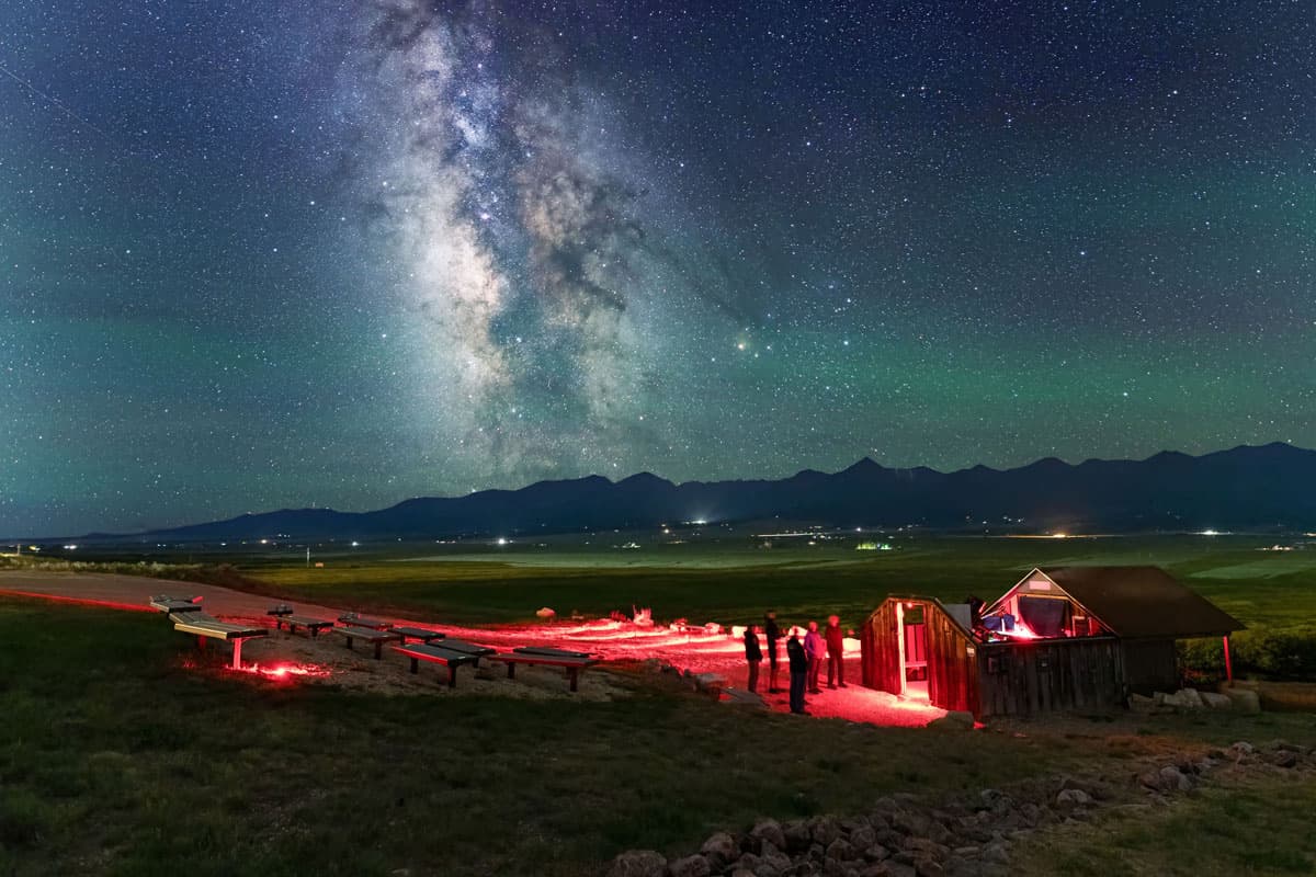 Smokey Jack Observatory at night with sparkling stars in the sky above in Westcliffe, Colorado.