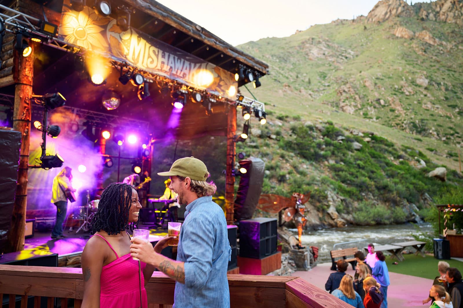 Two people talk near the stage that the outdoor Mishawaka amphitheatre