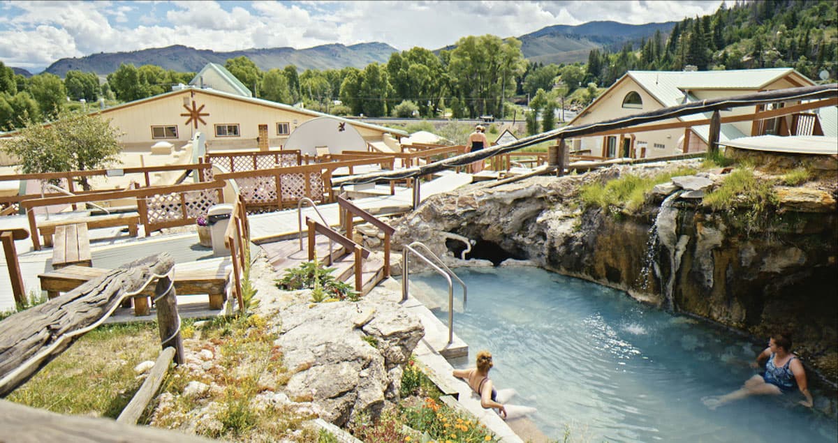 Hot sulphur springs surrounded by resort buildings and mountains