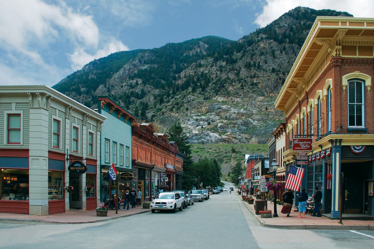 Western-style architecture on a downtown street in Georgetown. A mountain is visible in the background