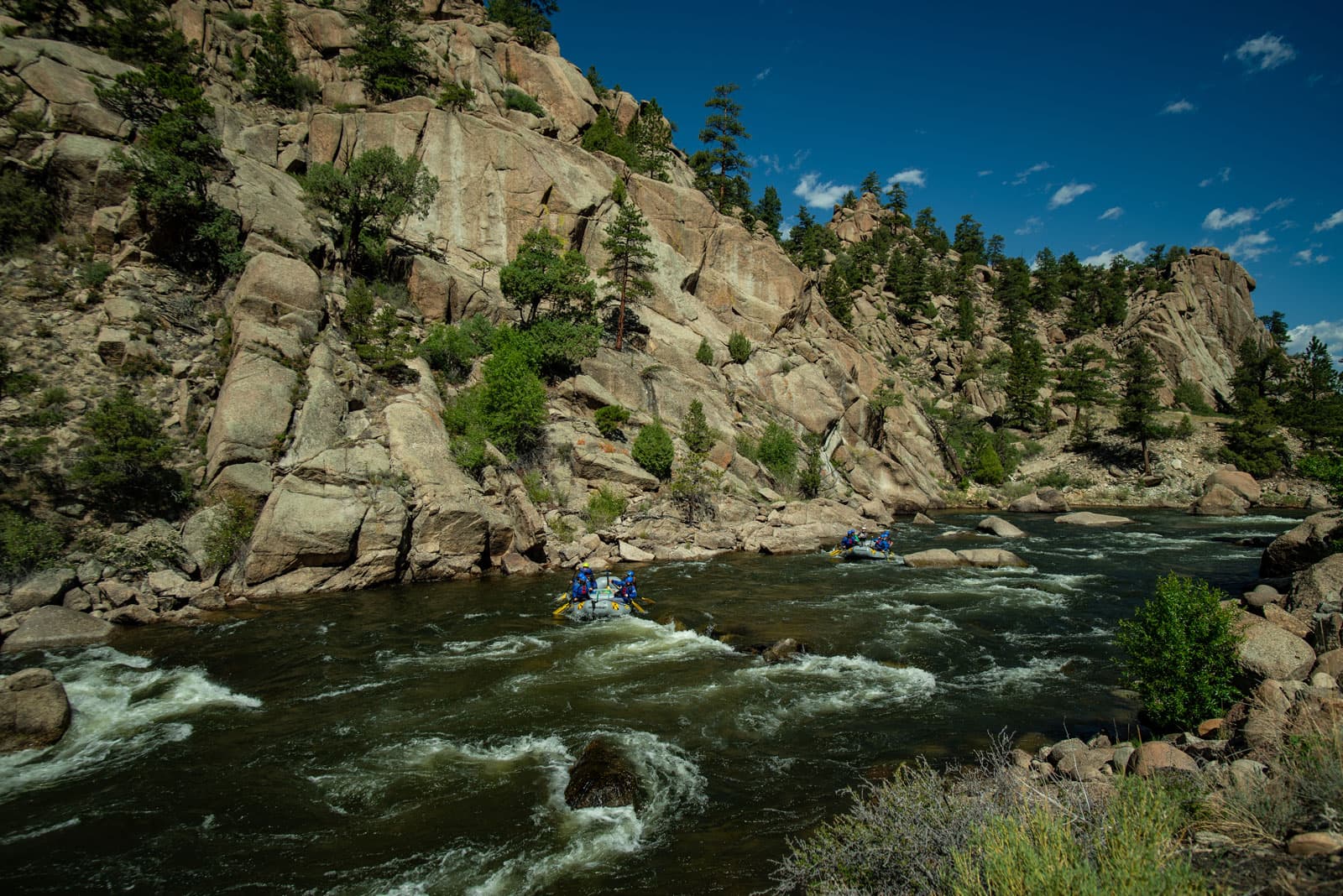 Whitecapped rapids rush between canyon walls