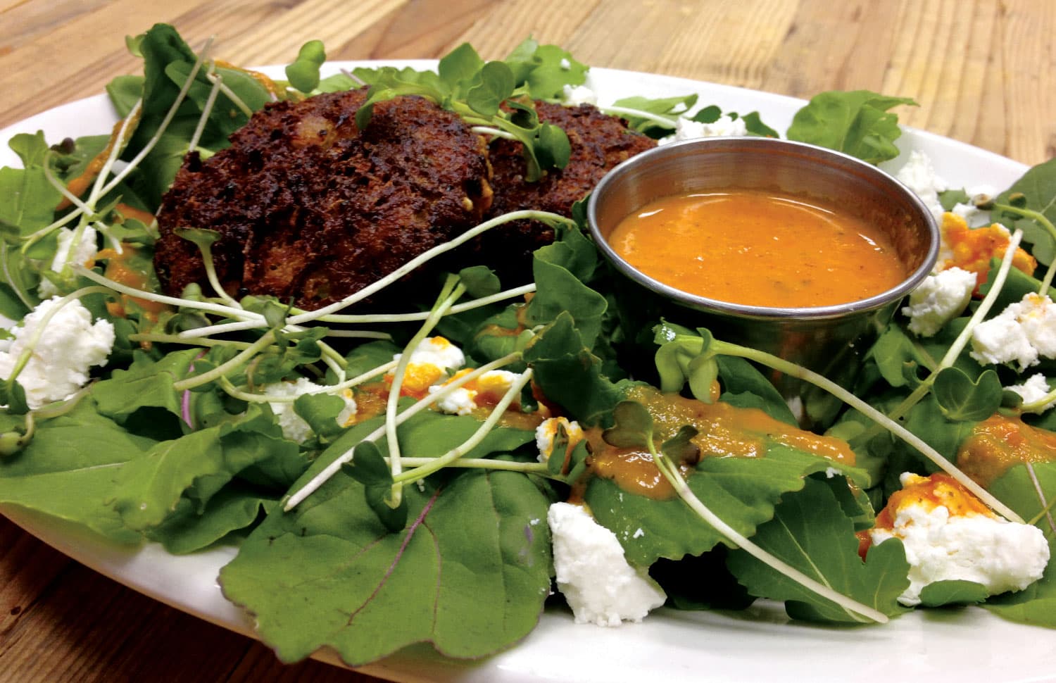 Zucchini fritters are served atop a bed of lettuce, watercress and creamy goat cheese with a light drizzle of dressing at at The Farm Bistro in Cortez, Colorado.