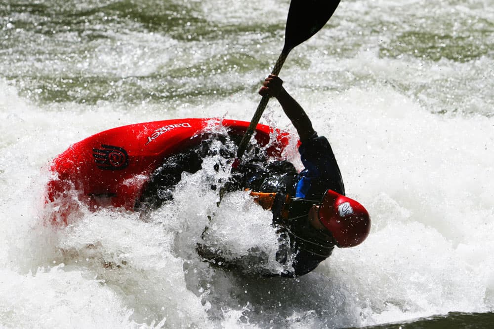 An experienced kayaker battles whitewater waves on the Arkansas River near Buena Vista, Colorado.