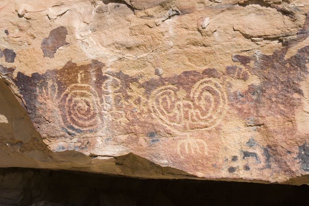 A tan-rock covered in Petroglyphs in  Ute Tribal Park in Towaoc.