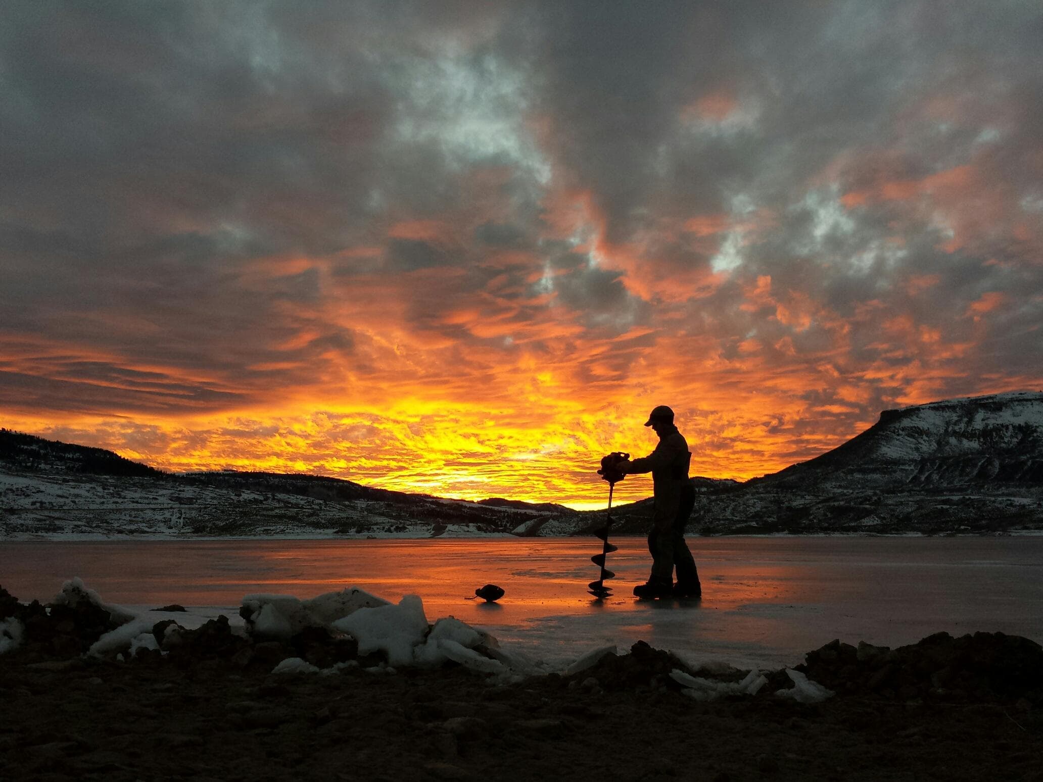 ice fishing sunset photo