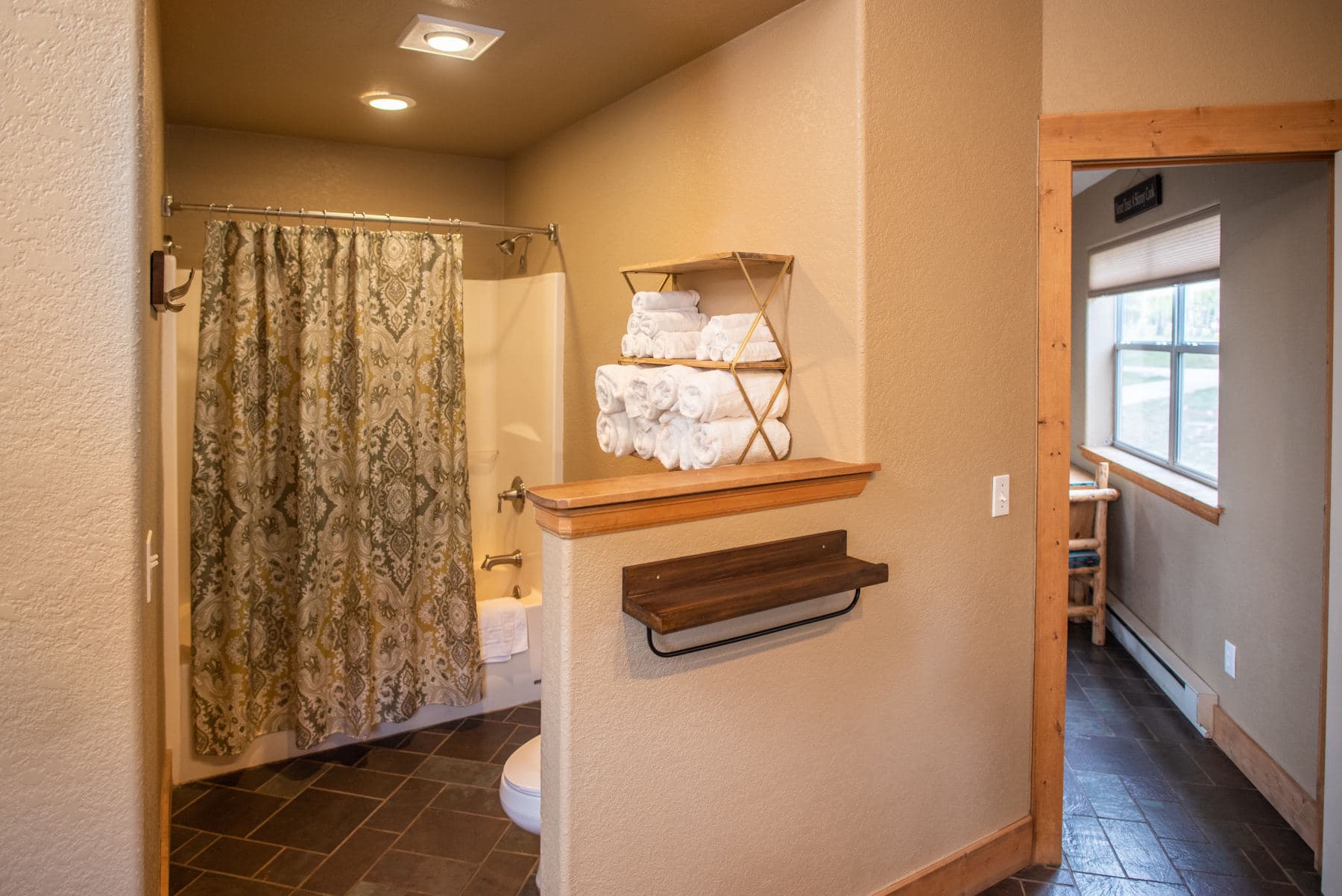 the spacious bathroom has a shower & bathtub and fully stocked with bath towels, wash cloths, hand towels, bath mats & complimentary toiletries. photo 3