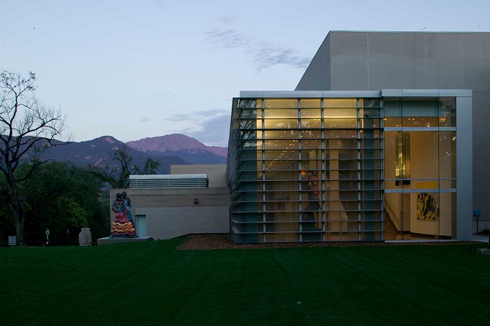 Exterior of an arts building with mountains behind it