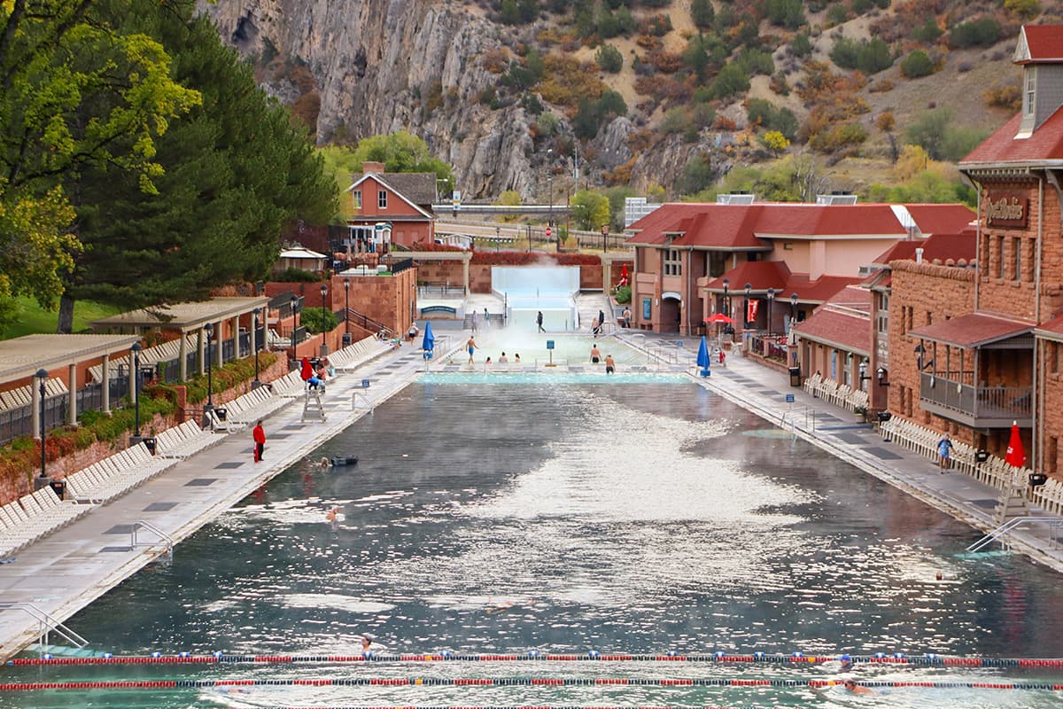 At Glenwood Hot Springs Resort, lifeguards patrol the edge of the pool while bathers swim or soak in the steaming waters.