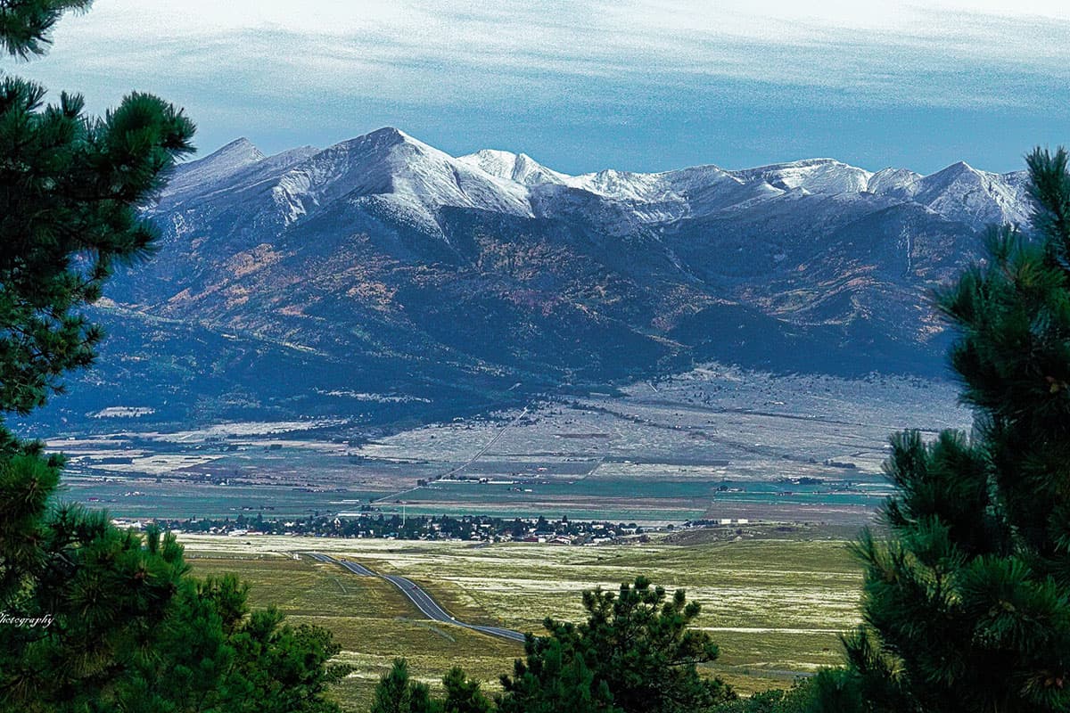 Snow-capped mountains rising over the small town of Silver Cliff in Colorado.