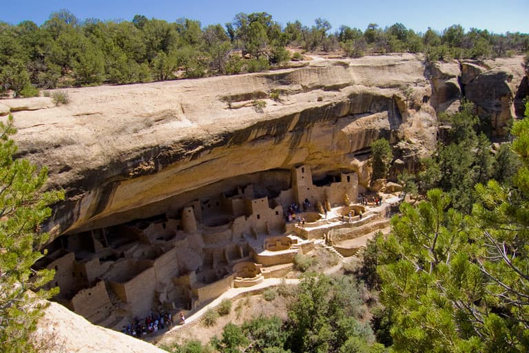 Cave dwellings are carved into a large rock face