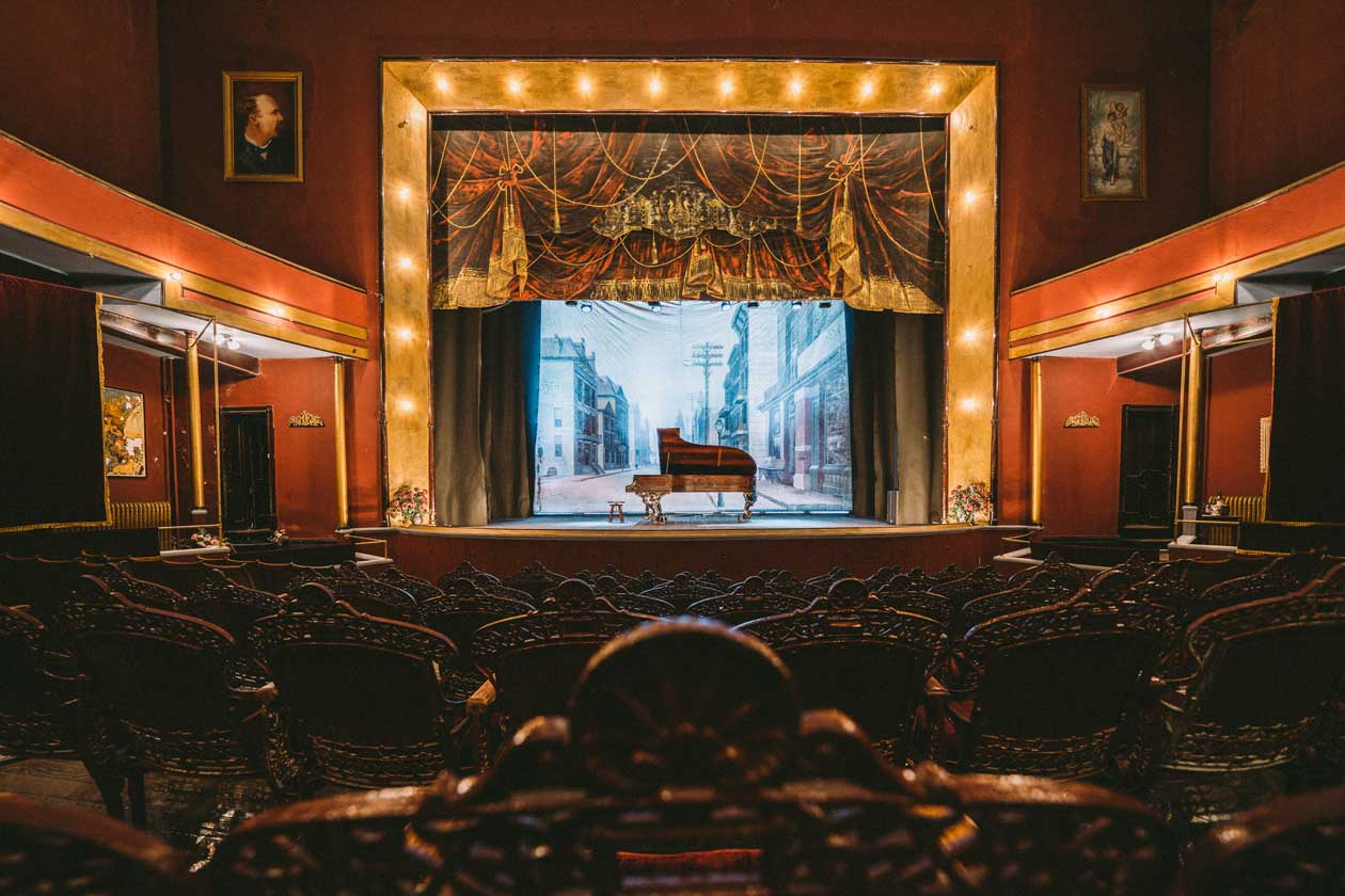 The stage lit up in a historic opera house