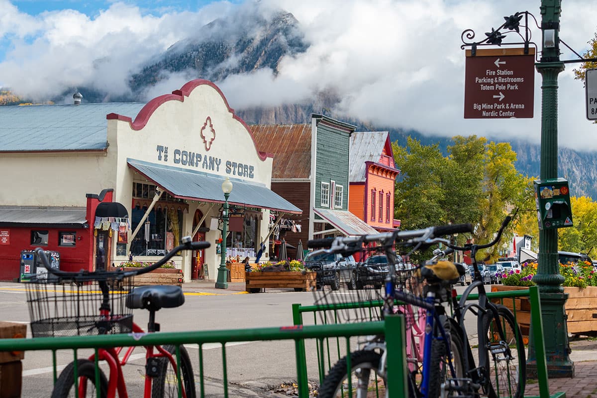 Street scene of colorful buildings and bicycles with a mountain looming in the background