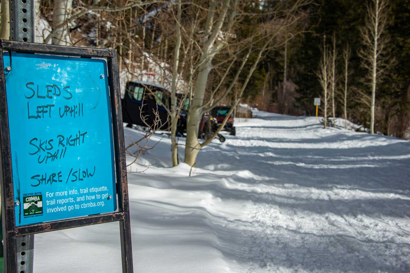 A sign at the trailhead for Cement Creek Road with instructions for sharing the trail