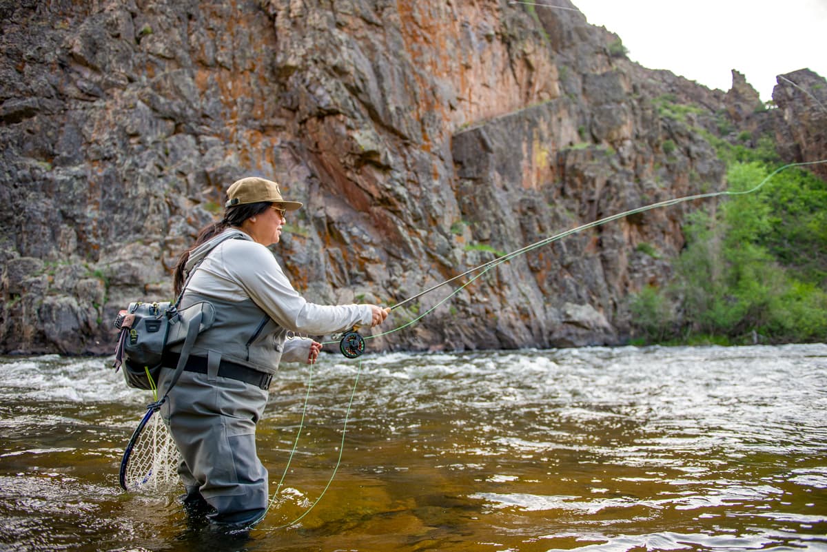 A person fly-fishes in a canyon in the Gold Medal waters of the Gunnison and Taylor Rivers in Gunnison and Crested Butte Colorado
