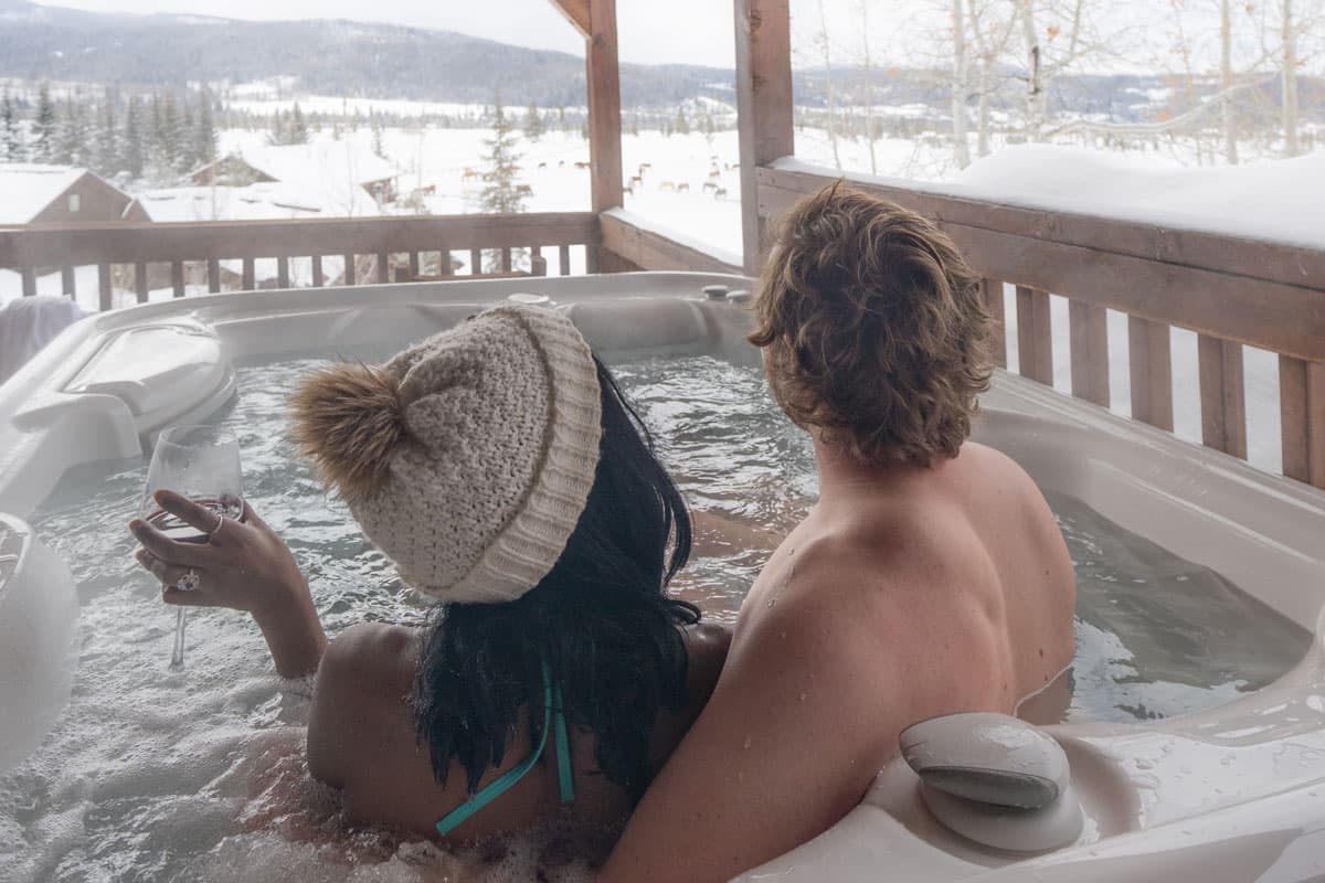 couple enjoying a warm hot tub with wintry outdoor views at Vista Verde in Colorado