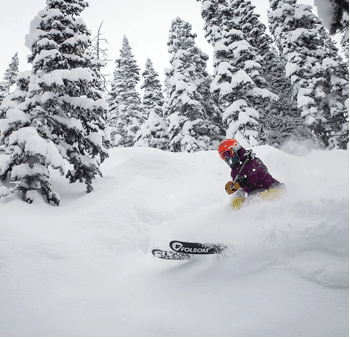 A skier slides through fresh powder