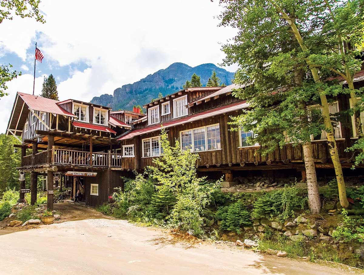 Exterior of wooden walls of Baldpate Inn in Estes Park on a sunny day